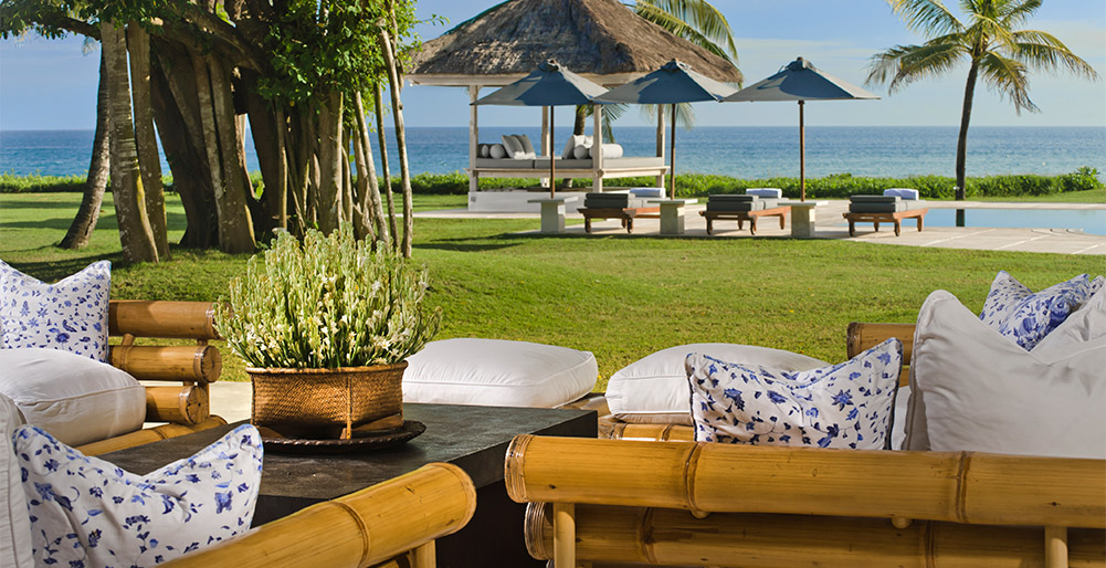 Atas Ombak - Living pavilion sofas with a view over the pool and sea beyond